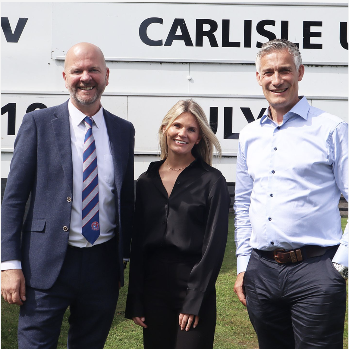 Norbreck’s CEO and Operations Manager stand next to Fylde AC’s Commercial Manager Anthony McCluskey